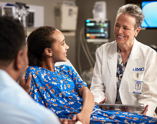 UMC nurse looking at patient