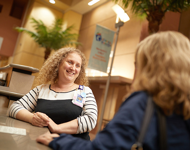 UMC employee talking with patient