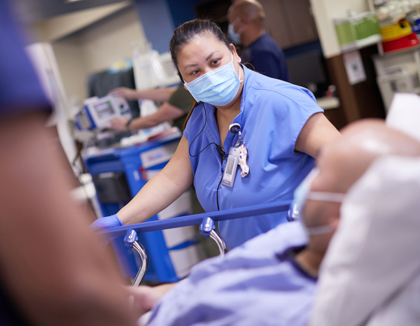 UMC nurse looking at patient