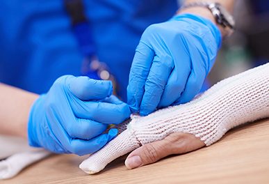 UMC doctor taking bandage off patient