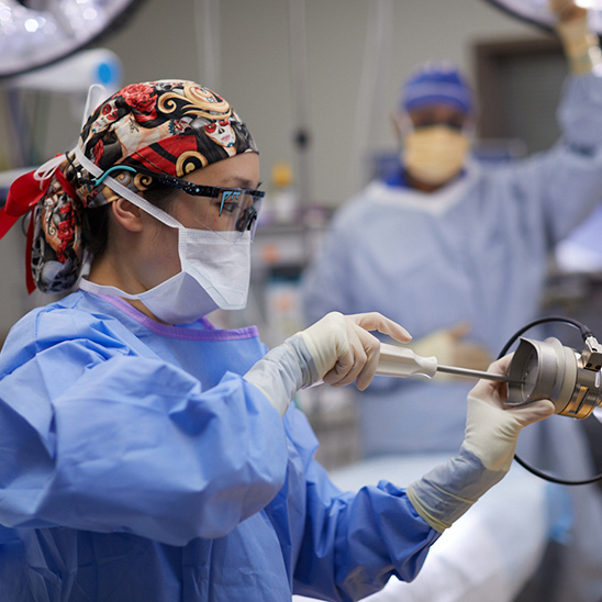 UMC medical resident with mask working on machine