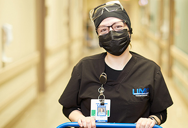 UMC physical therapy tech pushing a cart