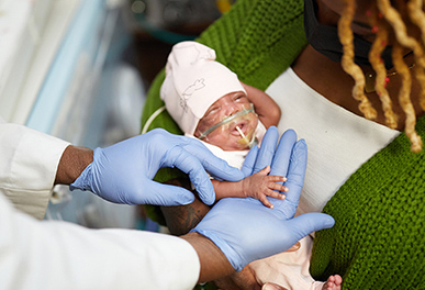 UMC doctor with baby and parent